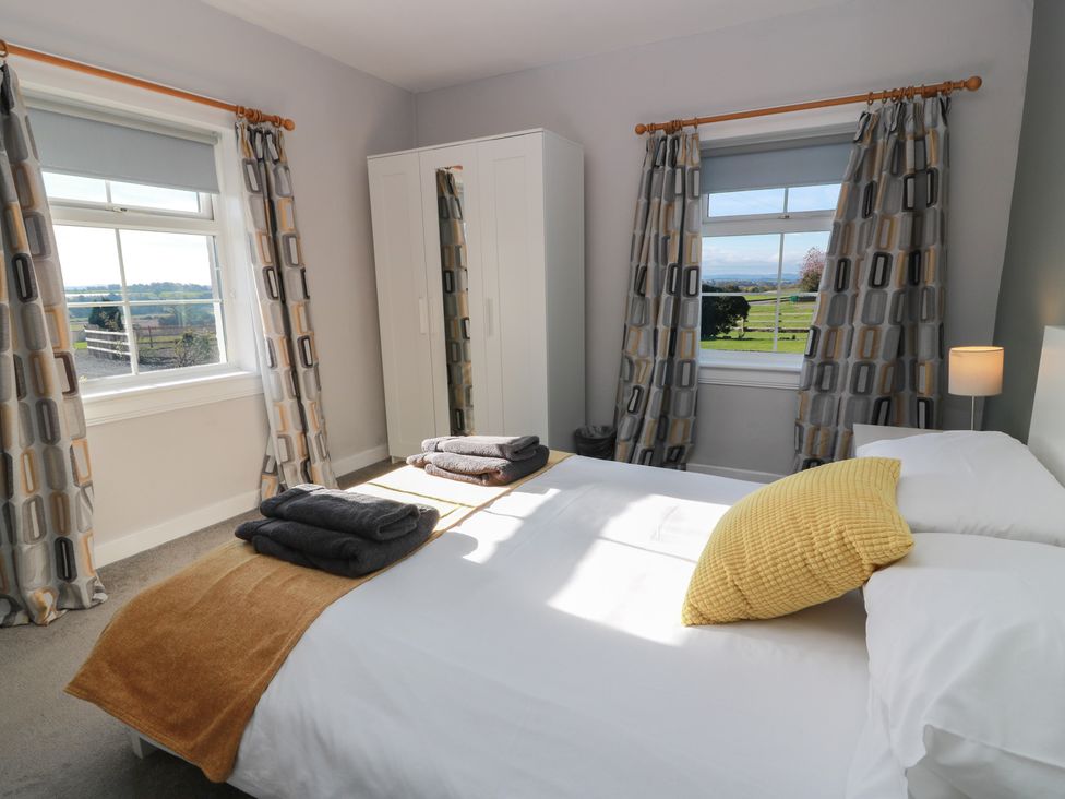 A bedroom with a bed and wardrobe at The Bothy in Blairgowrie