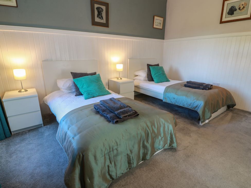 A bedroom with two beds and nightstands at The Bothy in Blairgowrie