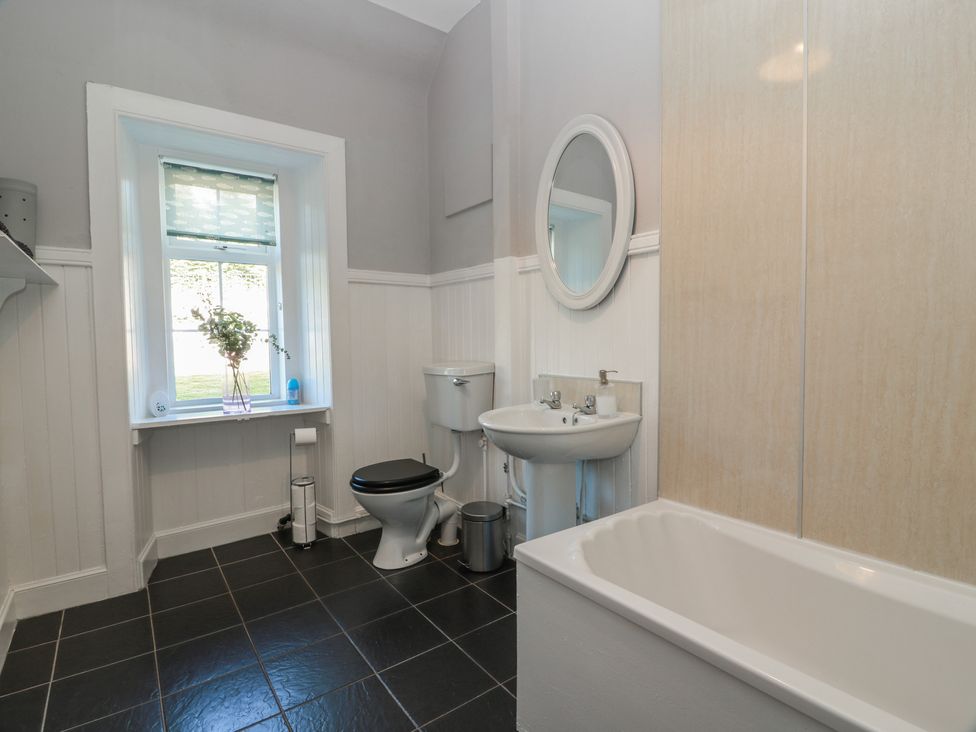 A bathroom with a sink, toilet, and bathtub at The Bothy in Blairgowrie