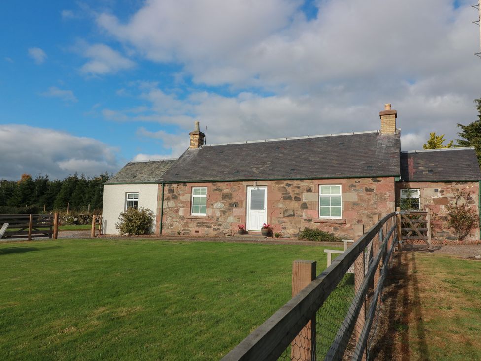A cottage with a garden and fence at The Bothy in Blairgowrie