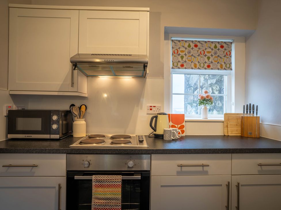 A kitchen with a stove and microwave at The Bothy in Blairgowrie