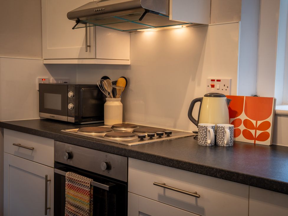 A kitchen with a microwave and kettle at The Bothy in Blairgowrie