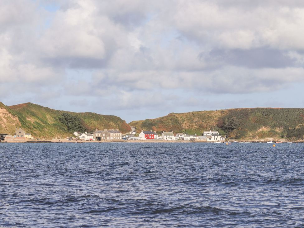 A view of a coastal village and hills at Gelli - Morfa Nefyn