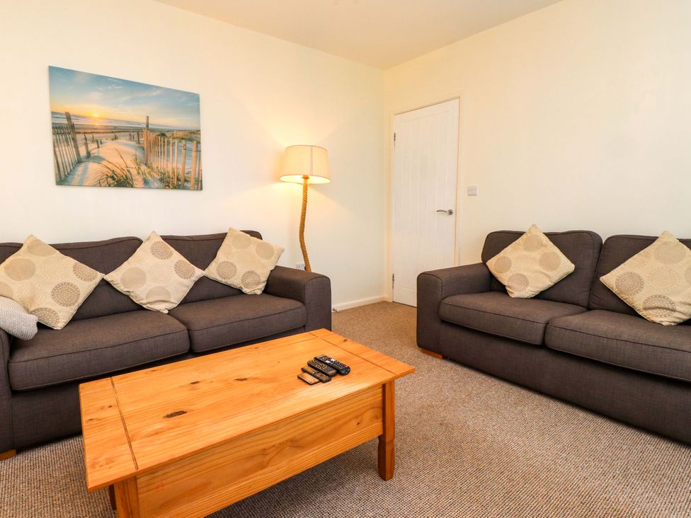 A living room with two sofas and a coffee table at Gelli - Morfa Nefyn in Morfa Nefyn