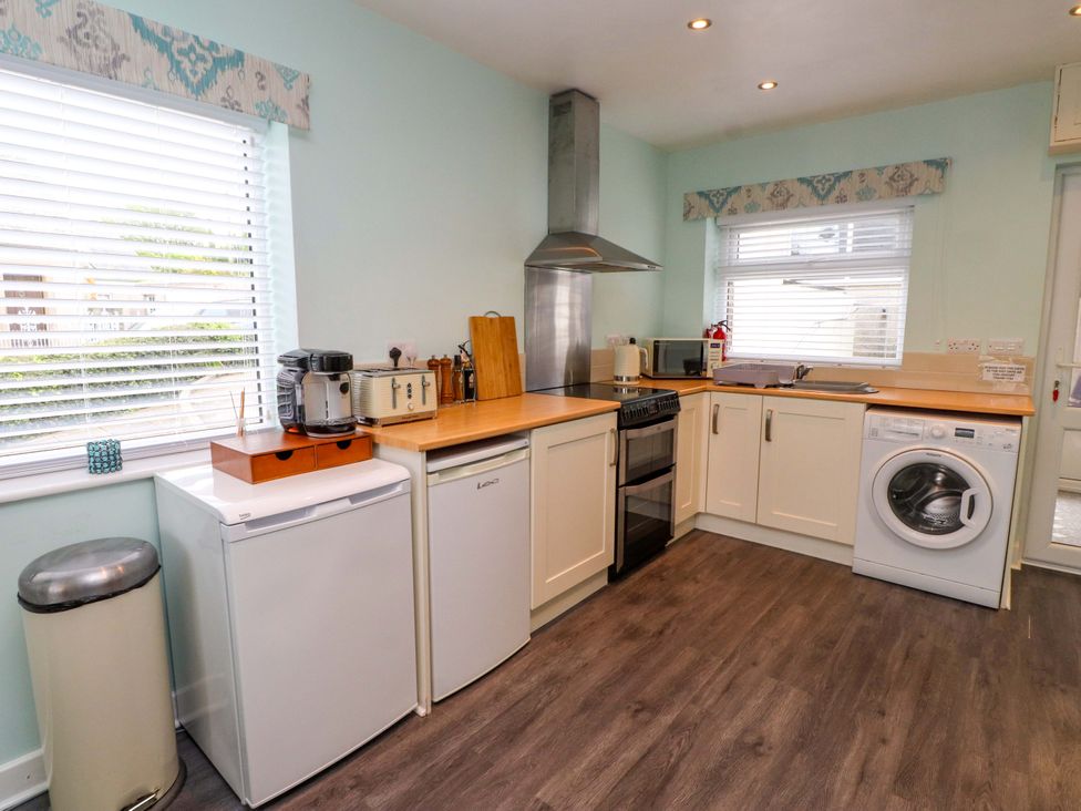 A kitchen with appliances and counter space at Gelli - Morfa Nefyn