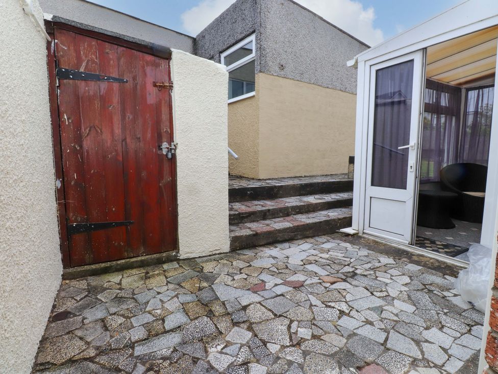 An outdoor area with a door, steps, and a room entrance at Gelli - Morfa Nefyn
