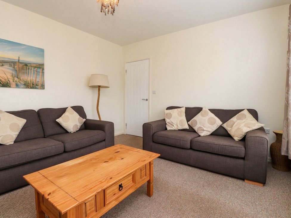 A living room with sofas and a coffee table at Gelli - Morfa Nefyn