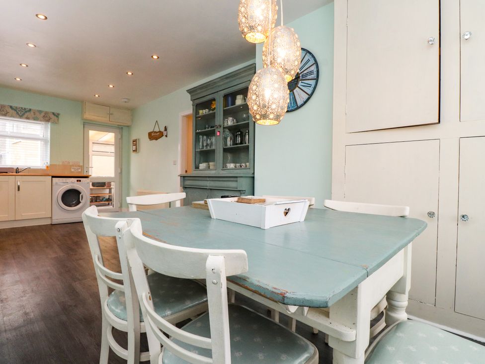A kitchen with a table and chairs at Gelli - Morfa Nefyn, Morfa Nefyn