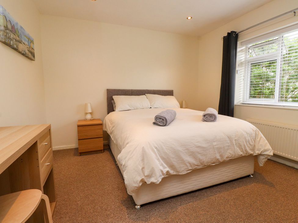 A bedroom with a bed and furniture at Gelli - Morfa Nefyn in Morfa Nefyn