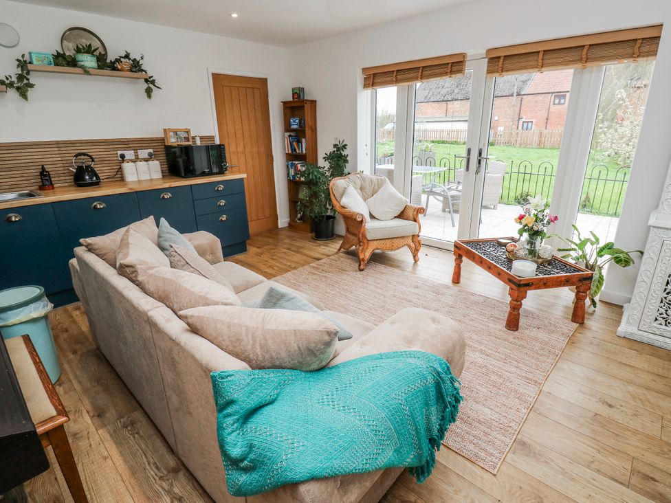 A living room with a sofa and table at The Retreat in 