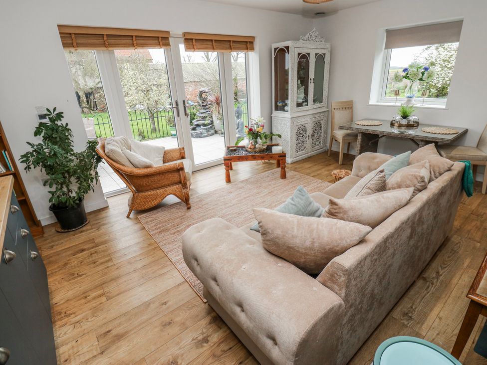 A living room with a sofa and tables at The Retreat in 