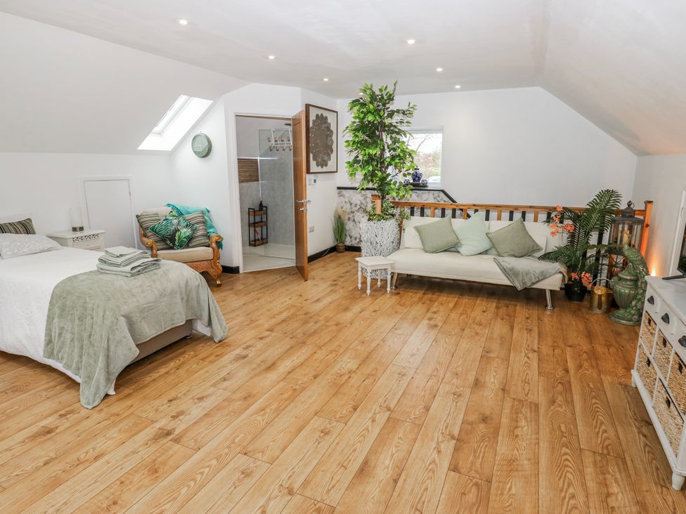 A bedroom with a bed and sofa at The Retreat