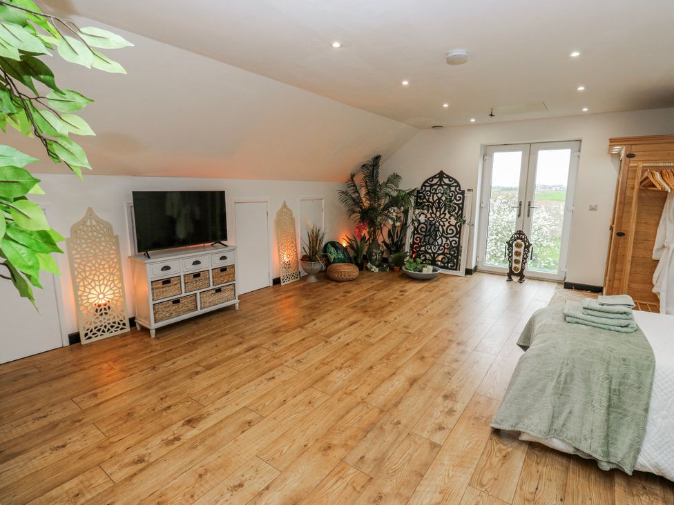 A bedroom with a television and storage unit at The Retreat in 