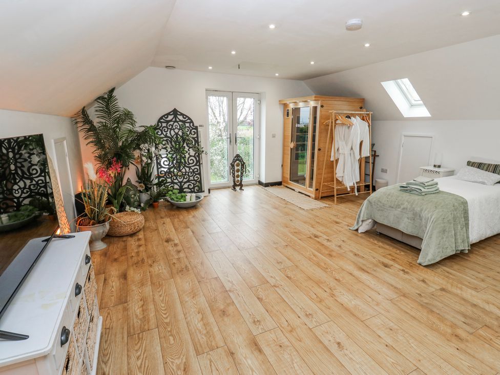 A bedroom with a bed and a spa unit at The Retreat in 