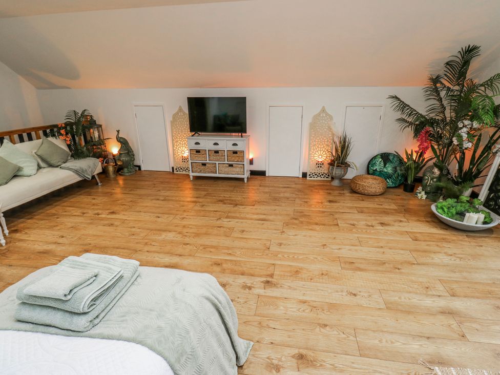 A loft with a sofa and television at The Retreat