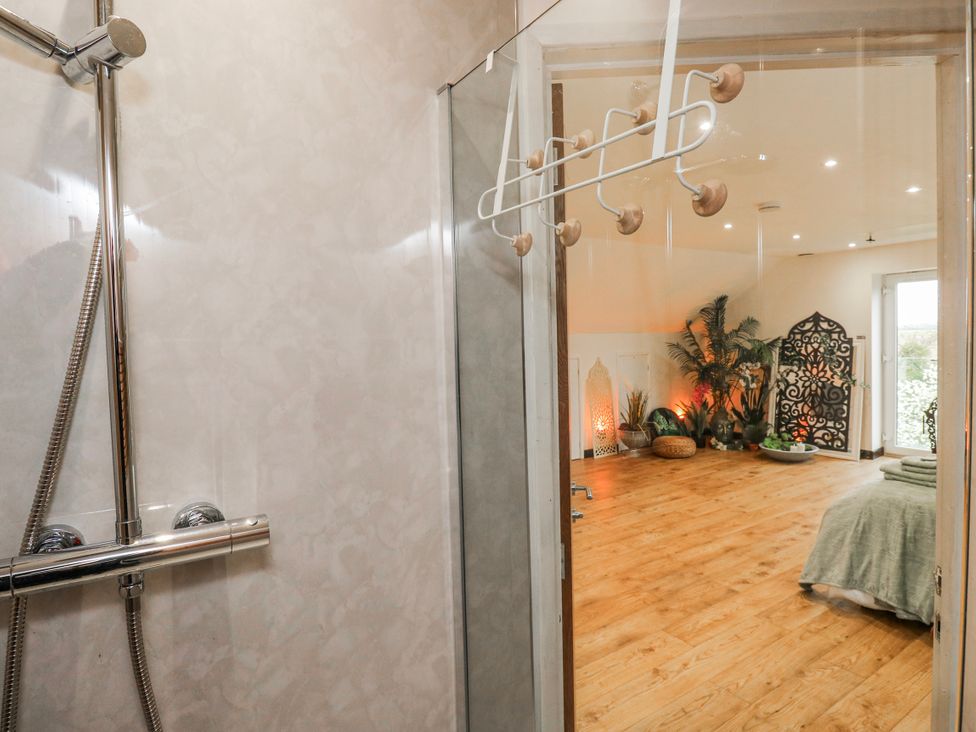 A bathroom with a shower and an open space view at The Retreat