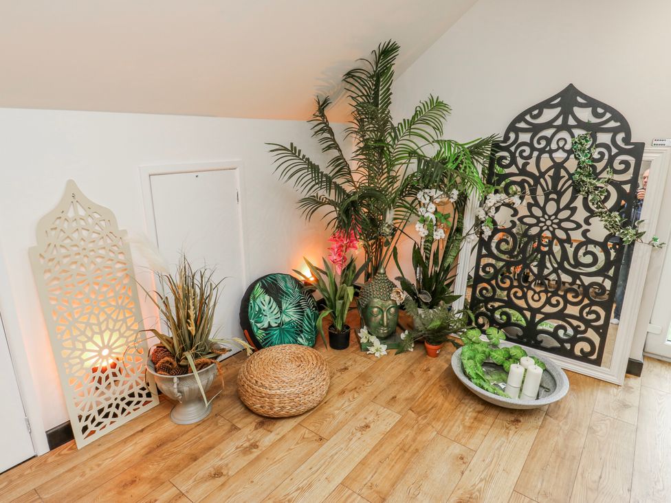 A decorative corner with plants and accessories at The Retreat