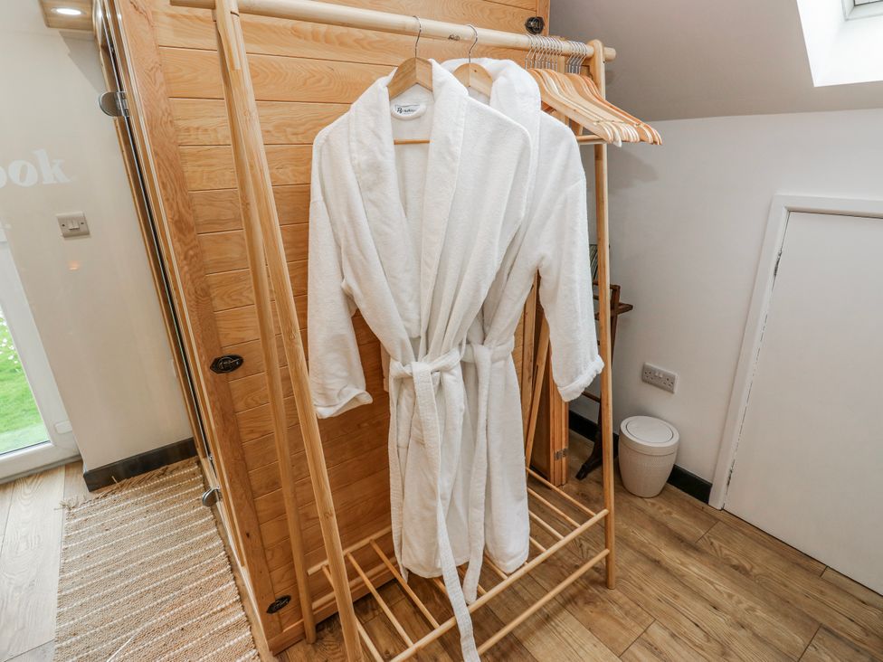 A robe on a rack in a bathroom at The Retreat
