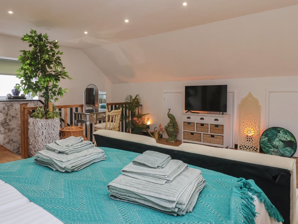 A bedroom with a bed and television at The Retreat in Snaith