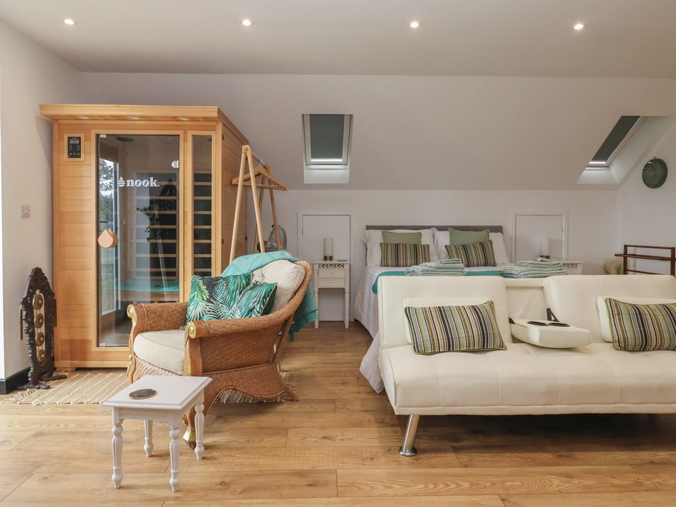 A bedroom with a sofa and sauna at The Retreat in Snaith