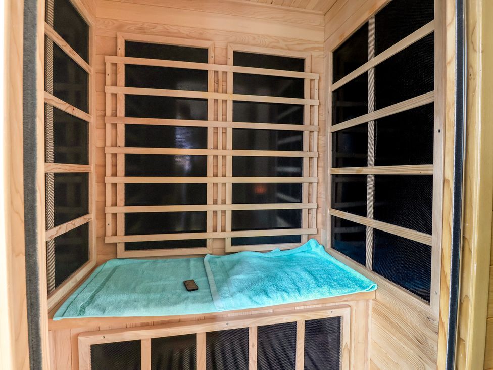 A sauna with wooden panels and a bench at The Retreat in Snaith
