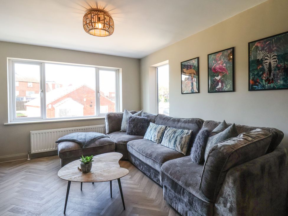 A living room with a sofa and coffee table at Falcon Luxe in Whitby