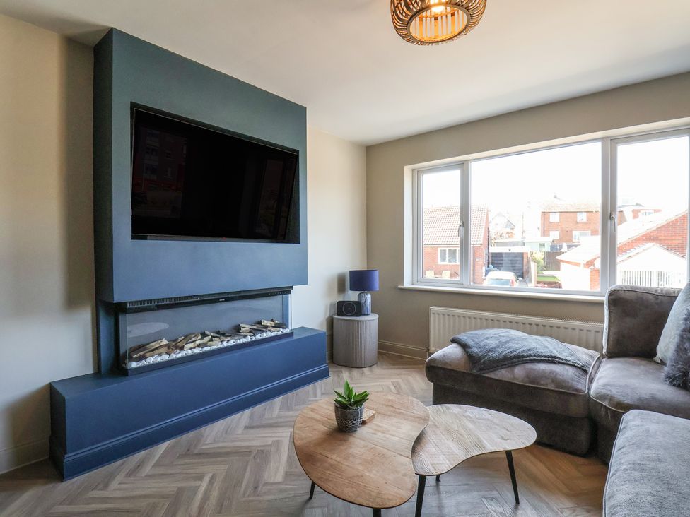 A living room with a television and fireplace at Falcon Luxe in Whitby