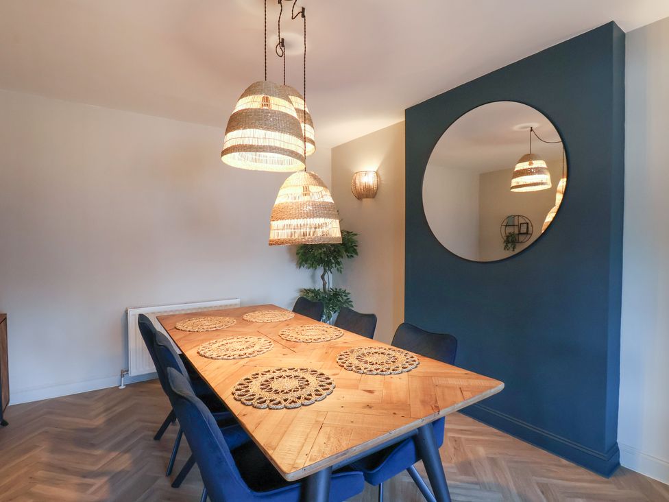 A dining room with a wooden table and chairs at Falcon Luxe in Whitby