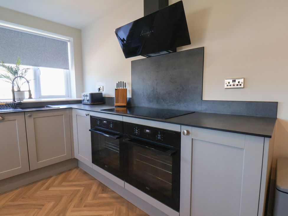 A kitchen with an oven and a window at Falcon Luxe in Whitby