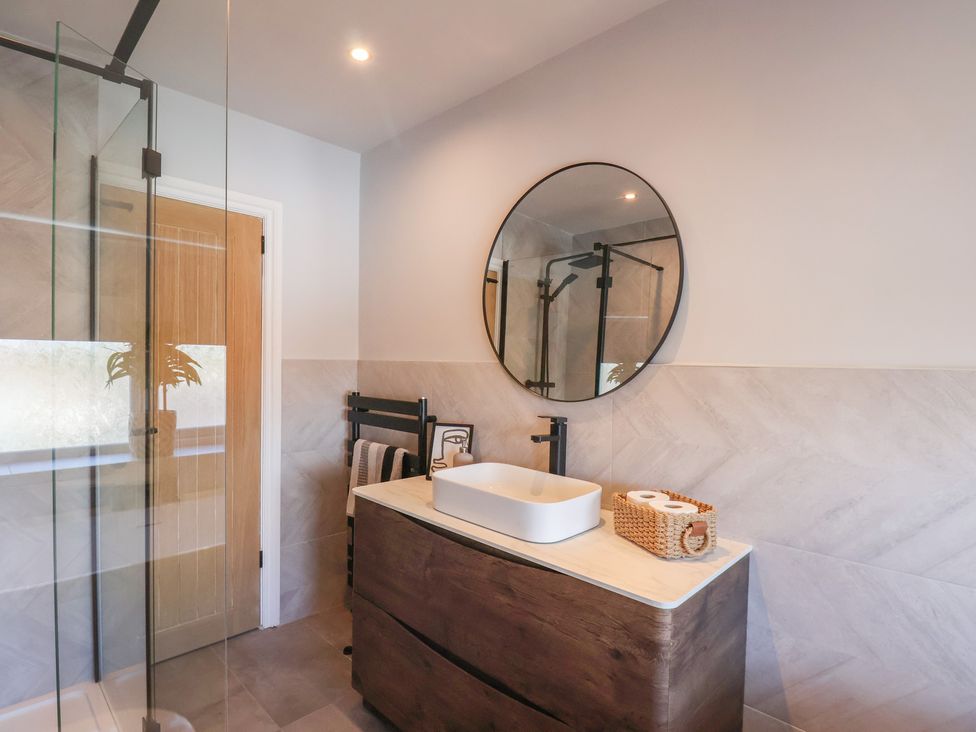 A bathroom with a sink and mirror at Falcon Luxe in Whitby