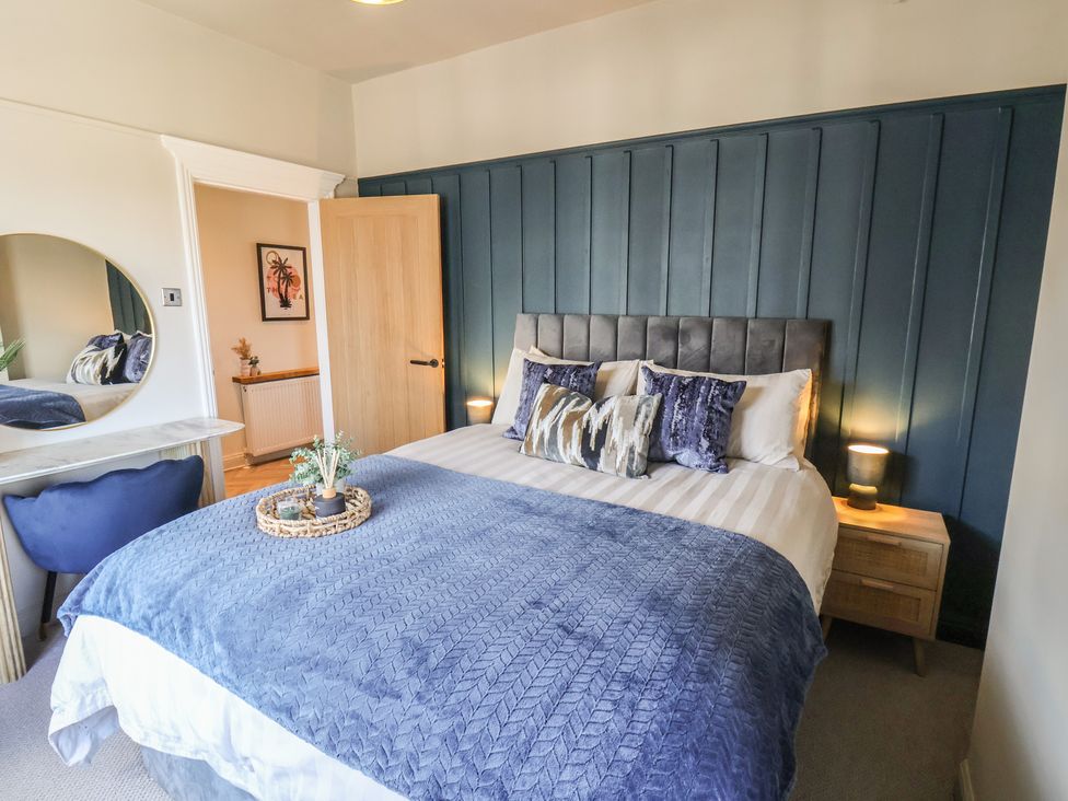 A bedroom with a bed and a mirror at Falcon Luxe in Whitby