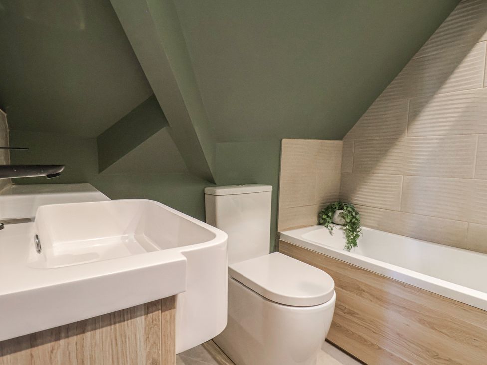 A bathroom with a sink, toilet, and bathtub at Falcon Luxe in Whitby