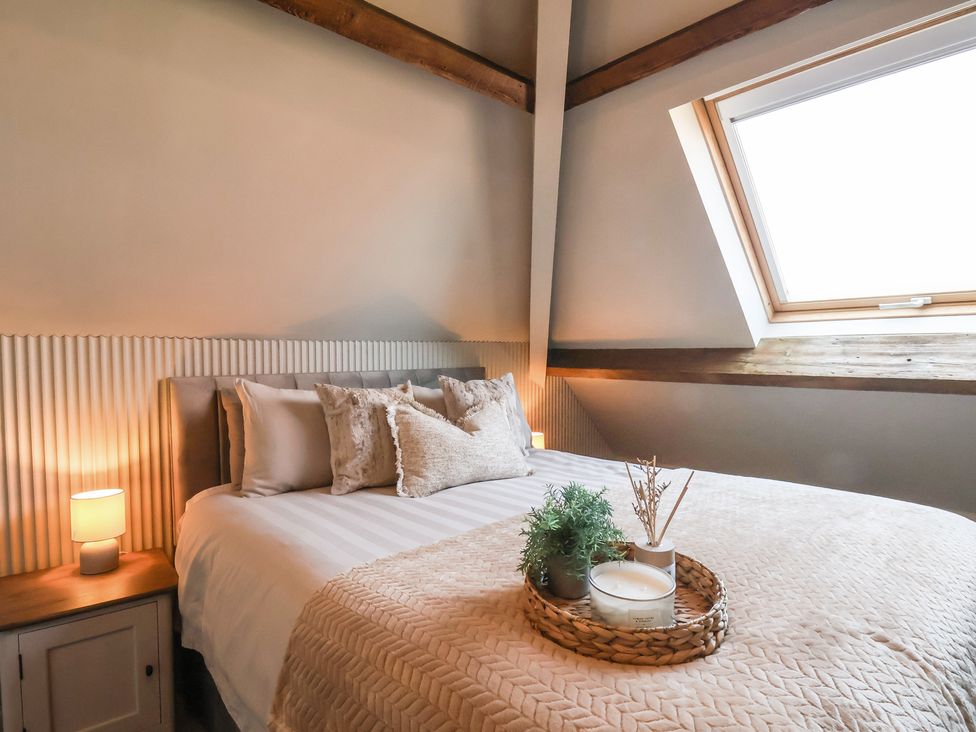 A bedroom with a bed and window at Falcon Luxe in Whitby