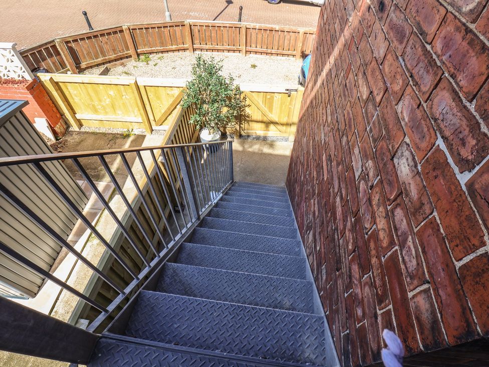 A staircase leading down to a garden area at Falcon Luxe in Whitby
