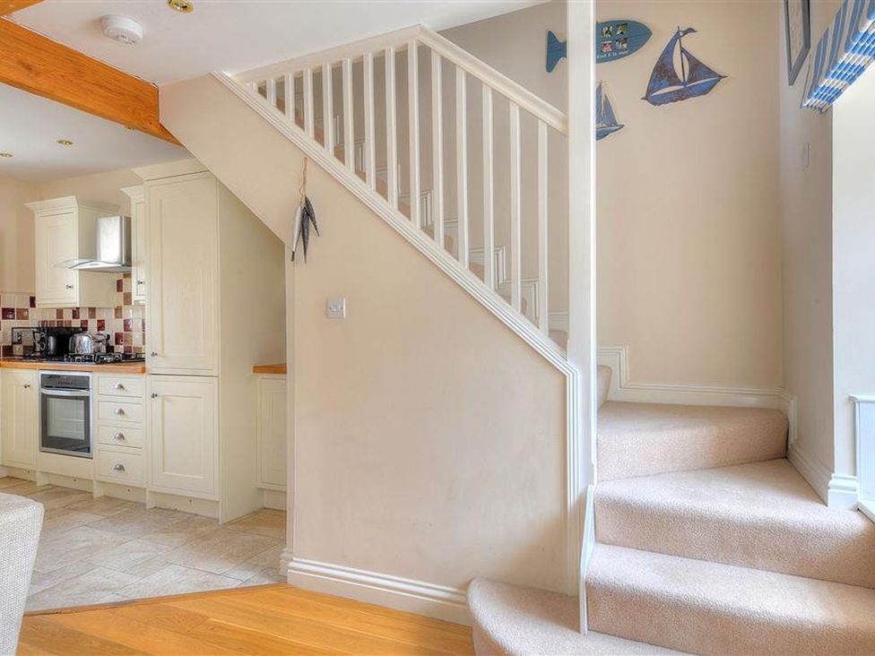 A kitchen with staircases at Half Moon Cottage in Lyme Regis