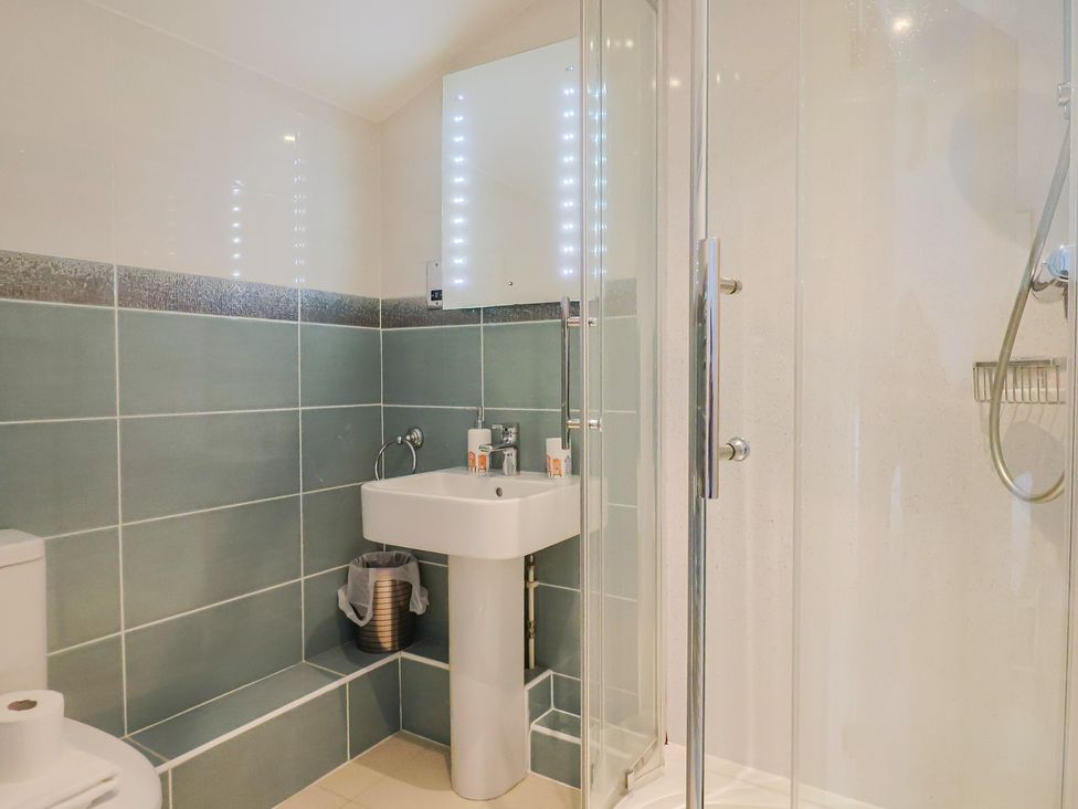 A bathroom with a sink and shower at Half Moon Cottage in Lyme Regis