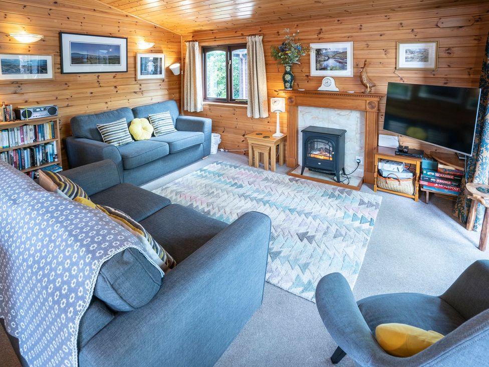 A living room with sofa and television at Watendlath in Keswick