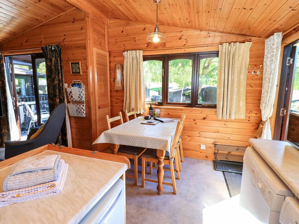 A dining room with a table and chairs at Watendlath in Keswick