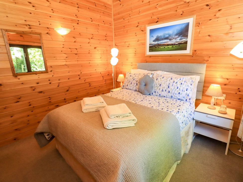 A bedroom with a bed and window at Watendlath in Keswick