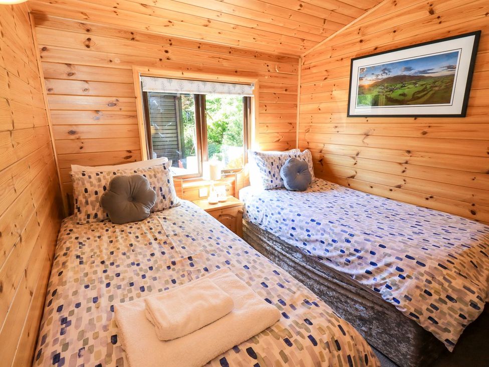 A bedroom with two beds and a window at Watendlath in Keswick