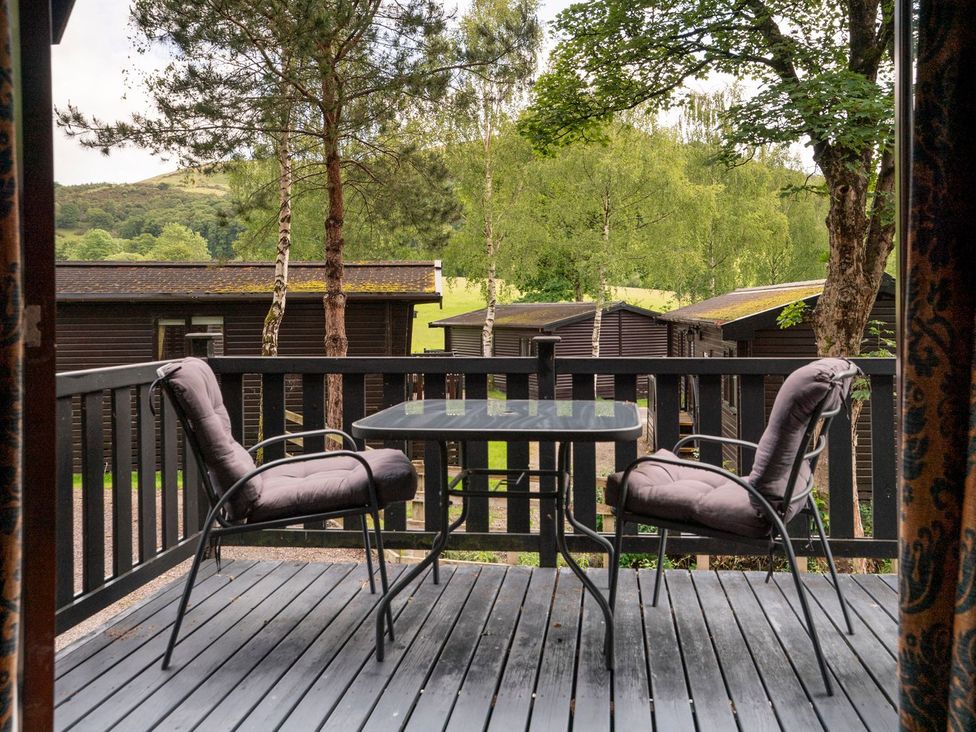 A deck with two chairs and a table at Watendlath in Keswick