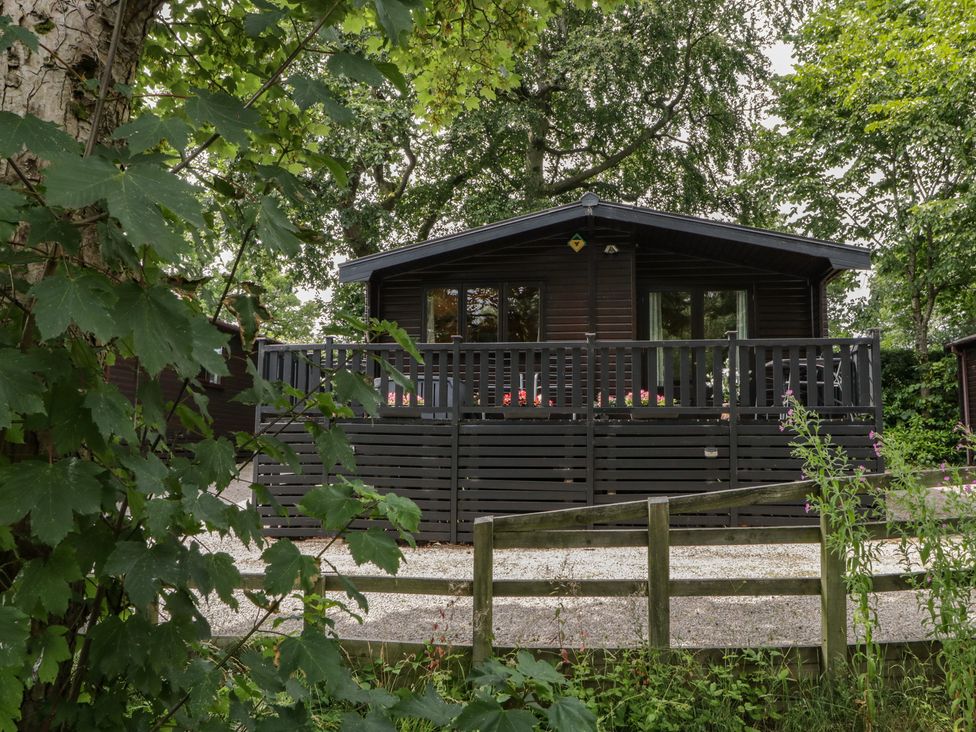 A cabin with a deck and fence at Watendlath in Keswick