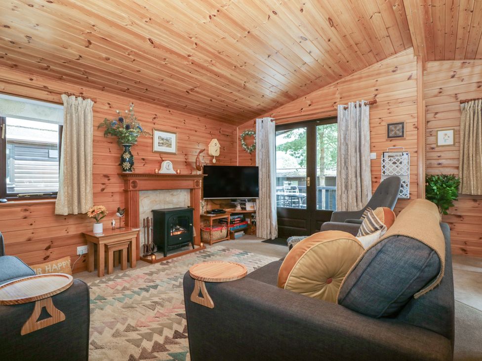 A living room with a television and fireplace at Watendlath in Keswick