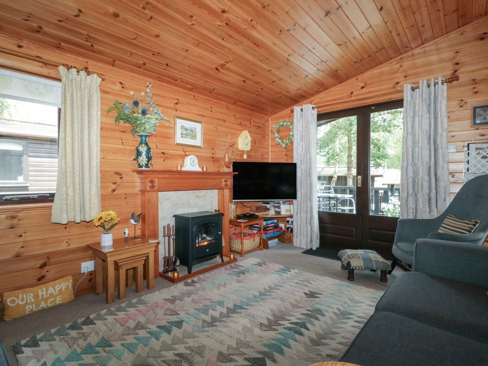 A living room with a television and fireplace at Watendlath in Keswick