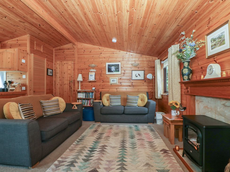 A living room with a sofa and fireplace at Watendlath in Keswick