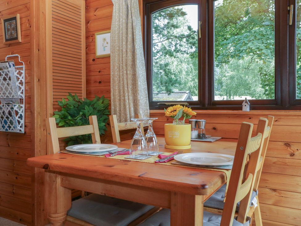 A dining room with a table and chairs at Watendlath in Keswick