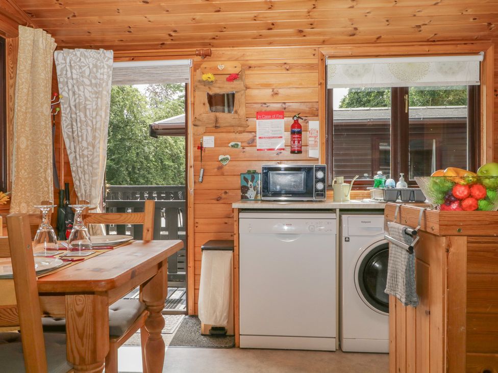 A kitchen with appliances and a dining table at Watendlath in Keswick