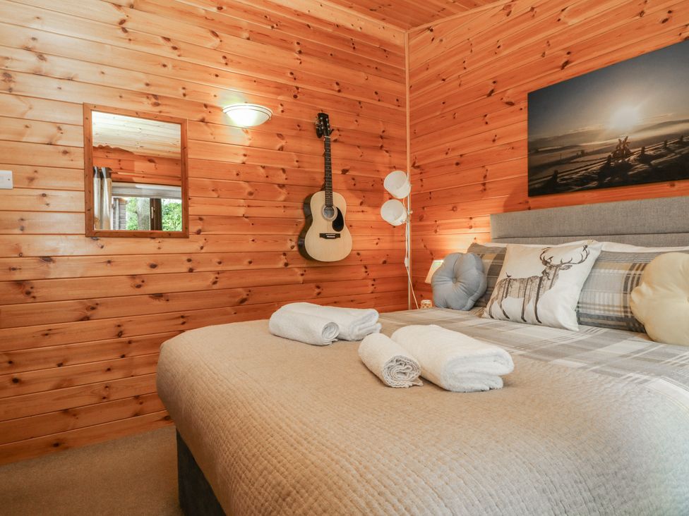 A bedroom with a guitar on the wall at Watendlath in Keswick