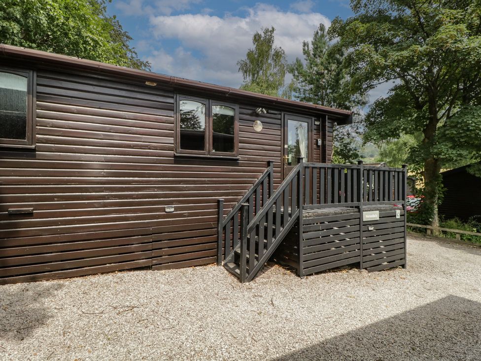 An outdoor view of a wooden cabin with steps and windows at Watendlath in Keswick