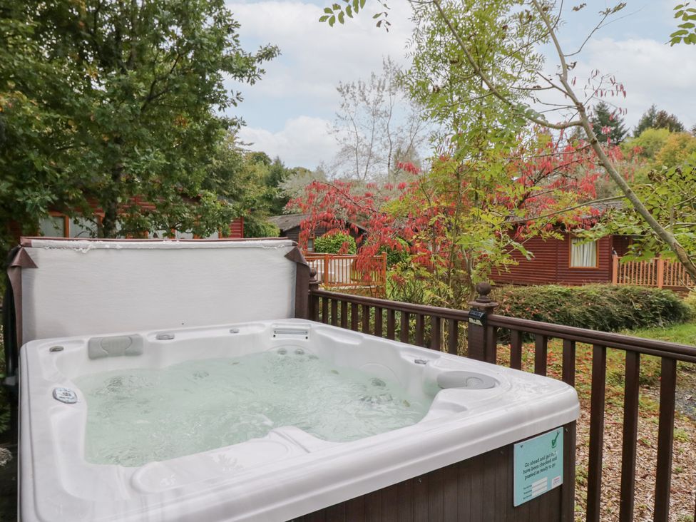 A hot tub on a wooden deck in an outdoor area at Costapacket in Windermere